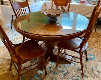 Glass top, oak table with 4 spindle back chairs 
