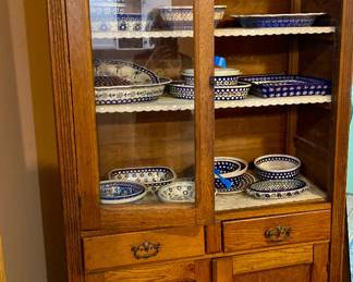 Antique cabinet full of Polish Pottery 