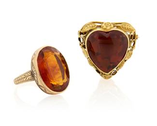 1113 A 14K Gold and Citrine Ring and Brooch Including an etched ring centering an oval citrine, together with a heart-shaped brooch centering a mixed-cut citrine 2 pieces  Ring: 5, Brooch: 1 x 1 in. 13.6 grams gross Estimate: $700 - $900
