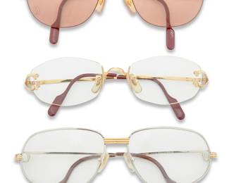 1240 Cartier: A Group of Sunglasses and Optical Frames Comprising three pairs of Cartier eyeglasses, including a pair of non-prescription sunglasses (size: 57.20.145), a pair of gold-toned rimless optical frames (no. 2201976, size: 18.130), and a pair of silver-toned prescription frames (circa 1986, size: 56.16.130), together with three Cartier red leather cases and one non-related hard case Each marked for Cartier, Made in France 7 pieces Estimate: $400 - $600