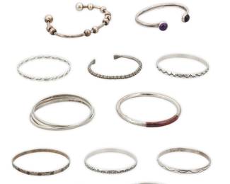 1198 A Large Group of Silver bracelets Comprising nine bangles and six narrow cuffs in various styles and sizes, including four with set stones such as turquoise, amethyst, and malachite, and one bangle with copper accent Variously marked for maker: Beau / RLG / SGT; five marked for Mexico; eleven marked for sterling, four unmarked 15 pieces  Largest 8 1/2 in. total inner C x 1/4 in.; smallest 5 5/8 in. total inner C x 3/8 in. 281.2 grams gross Estimate: $200 - $400