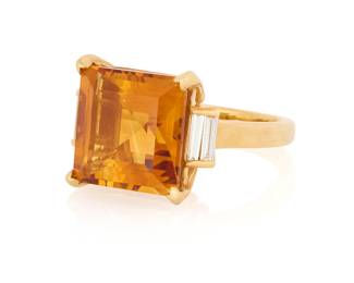 1171 An 18K Gold and Citrine Ring Centering a square step-cut citrine measuring approximately 12.91 x 12.90 x 8.35 mm, flanked by four baguette diamonds  Size: 7 1/2 18.3 gram gross Estimate: $1,800 - $2,200