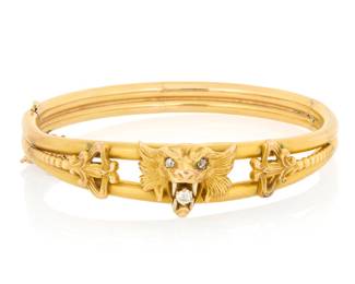 1049 An Antique 14K Gold and Diamond Bangle Of a hinged design centering a roaring lion motif set with old mine-cut diamonds  Inner circumference: 6 1/2 in. 19.4 grams gross Estimate: $1,000 - $1,500