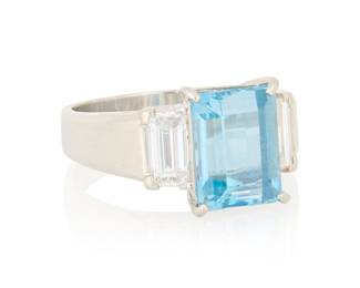1145 A Platinum, Aquamarine and Diamond Ring Centering and emerald-cut aquamarine measuring approximately 10.16 x 7.79 x 6.27 mm, flanked by two baguette diamonds  Size: 7 7.9 grams gross Estimate: $1,800 - $2,200