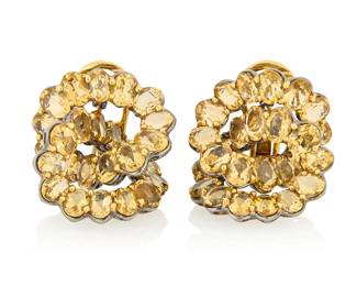 1083 A Pair of 18K Bi-Color Gold and Citrine Earrings Featuring an interlocking design set with oval citrines in blacked and yellow gold 2 pieces  Measures: 1 x 1 in. 19.8 grams gross Estimate: $2,500 - $3,500