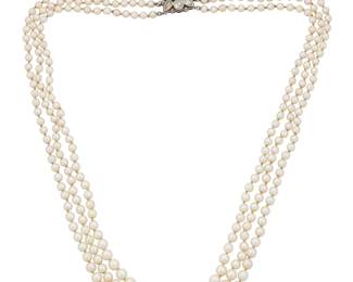 1151 A Cultured Pearl and Diamond Necklace Featuring three strands of graduated cultured pearls measuring approximately 3.80 - 7.05 mm, finished with a rose-cut diamond set clasp  Length: 19 1/2 in. 39.8 grams gross Estimate: $1,000 - $1,500
