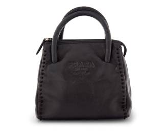 1236 Prada: A Vintage Mini Nappa Logo Black Leather Handbag Circa 1990s or later, Italy A smooth black leather bag with dual rolled leather handles, zip top, and knotted thread accents to sides, with two interior sections, branded black jacquard fabric rope motif lining, and one zip pocket Marked to interior plaque: Prada / Milano / Made in Italy / 925 / [hallmarks]; with interior tag: 53  7 x 8 x 4 in., drop: 2 1/2 in. Estimate: $200 - $400