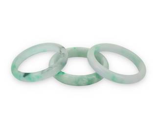 1129 A Group of Jade Bangles Including three solid jade bangles 3 pieces  Inner circumference: 7 1/2 in., 7 3/4 in. and 8 in. 178.0 grams gross Estimate: $1,200 - $1,800