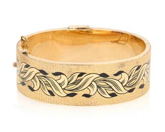 1047 A Victorian Gold and Enamel Bracelet Featuring a buckle design accented with a woven floral enamel motif  Inner circumference: 6 in. 33.4 grams gross Estimate: $1,000 - $1,500