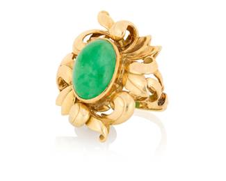1012 A 14K Gold and Jade Ring Featuring a foliate and scrolling motif, centering an oval jade cabochon weighing approximately 8.90 carats  Size: 6 1/2 13.2 grams gross Estimate: $1,800 - $2,200