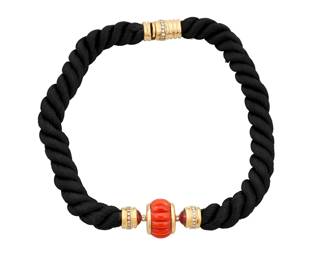 1117 An 18K Gold, Coral and Gem-Set Necklace Centering a carved fluted coral, accented by two pink tourmaline cabochons, accented by round diamonds, finished with a black twisted silk cord  Length: 16 in. 59.8 grams gross Estimate: $2,500 - $3,500