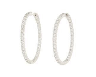 1074 A Pair of 14K White Gold and Diamond Hoop Earrings Featuring round diamonds half set inside and outside weighing approximately 5.60 carats 2 pieces  Measures: 1 3/4 in. dia. 14.4 grams gross Estimate: $2,800 - $3,500