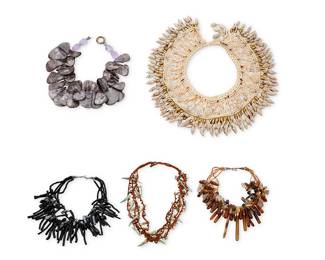 1214 Five Shell and Glass Bead Necklaces Comprising five necklaces of various sizes, each designed with various stone and shell beads including a wide macramé collar necklace with applied shell section beads and cowrie-style bead dangles (15 1/2 x 3 1/2 in.), a multistrand black glass bead necklace with faux black coral and grey pearls (17 x 2 1/2 in.), a four strand knotted cord necklace with green-toned shell and brown beads (24 in.), a multistrand necklace with brown bead strands and various tonal shell and stone spacers and tapered drops (17 x 2 1/2 in.), and a chunky single strand choker with purple shell and purple glass beads (16 in.), 5 pieces  832.3 grams gross Estimate: $200 - $400