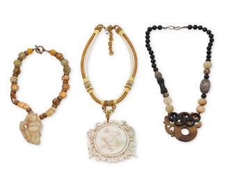 1211 Three East Asian-style Hardstone Necklaces Comprising a carved white hardstone disc plaque suspended from a multicolored cord (17 x 5 1/4 in. approximately), as well as two carved hardstone bead necklaces, one suspending a carved stone figure (16 x 2 1/2 in.), and one suspending a carved pierced stone dragon plaque with black stone overlay design (22 1/2 x 2 1/2 in.), 3 pieces  402.4 grams gross Estimate: $200 - $400