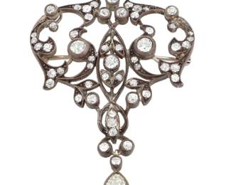 1133 A Sterling Silver Diamond Brooch Of an ornate scrolling design featuring old mine-cut diamonds weighing approximately 1.88 carats  Measures: 2 x 1 1/2 in. 8.2 grams gross Estimate: $300 - $500