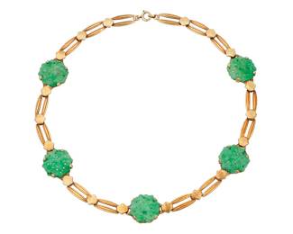 1013 A Gold and Jade Necklace Featuring geometric elongated links accented by five carved jade elements  Length: 15 1/2 in. 35.4 grams gross Estimate: $800 - $1,200