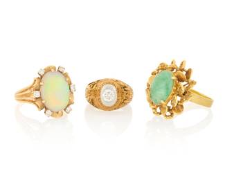 1101 Three Gold and Gem-Set Rings Including two 14k gold rings featuring an oval opal cabochon and an oval jade cabochon together with a 10k gold class ring centering a ring diamond 3 pieces  Size: 4 1/2 and 7 1/2 25.1 grams gross Estimate: $1,500 - $2,500