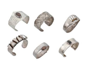 1194 Six Modernist-style Silver Cuff Bracelets A group of cuffs and bangles in various styles and sizes including a silver-toned copper cuff, a Mexican sterling silver hinged bangle with set tiger's eye cabochons, and two hammered sterling silver bracelets, each with a set brown stone Three variously marked for maker; three marked for sterling; two unmarked 6 pieces  Largest 7 in. total inner C x 2 in.; smallest 5 1/2 in. total inner C x 1 in. 275.5 grams gross Estimate: $200 - $400