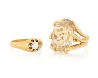 1112 Two 14K Gold Rings One centering an oval smokey quartz weighing approximately 16.00 carats, together with a ring featuring a simulant colorless stone  Size: 6 3/4 and 7 1/4 15.7 grams gross Estimate: $600 - $800