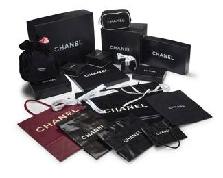 1265 CHANEL & Others: A Group of Luxury Packaging & Ancillary Items Circa 1980s and later A large group of various CHANEL branded presentation boxes for handbags, scarves, jewelry, watches, and small leather goods, as well as retail bags in various shapes, styles, and sizes, plus various dust bags, shoe bags, and branded CHANEL white and red ribbons, together with a couple of additional designer boxes and dustbags including Prada, Gucci, Louis Vuitton, Fendi, and others, approximately 44 boxes, 40 CHANEL retail bags, 30 dust bags, and multiple lengths of CHANEL ribbon  Largest box: 4 x 14 x 12 1/4 in. Estimate: $200 - $300
