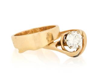 1175 A 14K Gold and Diamond Wedding Set Featuring an organic shaped ring set with a single round diamond weighing approximately 1.25 carats, together with a matching band 2 pieces  Sizes: 6 and 7 9.1 grams gross Estimate: $1,200 - $1,800