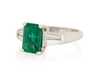 1144 A Platinum, Emerald and Diamond Ring Centering a cut-cornered rectangular step-cut emerald weighing approximately 2.10 carats flanked by four tapered baguette diamonds  Size: 6 7.9 grams gross Estimate: $3,000 - $5,000
