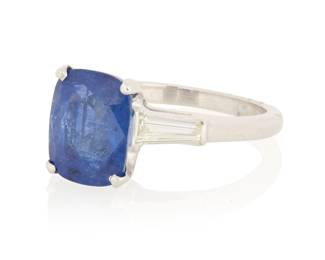 1141 A Platinum, Sapphire and Diamond Ring Centering a cushion-cut sapphire weighing approximately 4.00 carats, accented by two tapered baguette diamonds  Size: 5 3/4 5.1 grams gross Estimate: $1,800 - $2,500