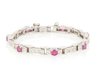 1039 A Platinum, Palladium, Ruby and Diamond Bracelet Featuring seven round rubies set in geometric rectangular links accented by round diamonds weighing approximately 0.70 carat  Length: 6 1/4 in. 19.2 grams gross Estimate: $1,800 - $2,200