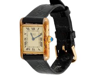 1061 Cartier: A Silver and Vermeil 'Must de Tank' Watch Dial: 15.00 mm, rectangular with Roman numeral hour markers Case: 20.50 mm Case number:  58838, 5057001 Closure: black leather strap with metal buckle Signed: dial and case  Inner circumference: 6 1/4 - 7 3/4 in. 18.1 grams gross Estimate: $300 - $500