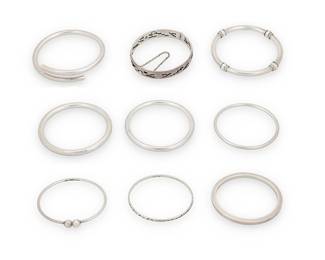 1203 Nine Sterling Silver Bracelets A group of mostly Mexican silver bangles in various sizes and shapes including a hinged oval bangle with geometric openwork motifs Seven variously marked for Mexico; nine marked for sterling 9 pieces  Inner circumference: 7 3/4 in. to 8 1/4 in. 211.7 grams gross Estimate: $400 - $600