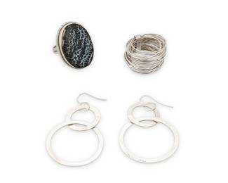 1193 A Group of Modernist-style Sterling Silver Jewelry Comprising a sterling silver ring with set petrified wood 'cabochon', a ring formed of stacked sterling silver wires, and a pair of Willa Wirth silver hoop dangle earrings, each marked for sterling, the earrings signed 4 pieces  Ring sizes 8 & 9; Earrings 2 1/4 x 1 3/8 in. 31.1 grams gross Estimate: $200 - $400