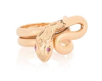 1089 A 14K Gold and Ruby Ring Of a high polish snake design, finished with two round ruby eyes  Size: 6 1/4 12.2 grams gross Estimate: $1,000 - $1,500