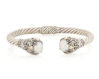 1078 A Silver, 18K Gold and Cultured Pearl Cuff Of twisted silver hinged cuff design, accented with 18k gold, each terminal set with a cultured pearl  Measures: 7 3/4 in. 28.1 grams gross Estimate: $200 - $400