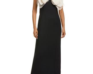 1224 Isaac Mizrahi: A Black & Cream Bow Front Gown Circa 2011 A long fitted black wool mix dress with a cream tulle and silk organza layered bow with picot edging, narrow cap-style set-in sleeves, back zip, and a black silk lining with center black split Label: Isaac Mizrahi / New York  Size 6 Measurements: back length from shoulder: 60 in.; bust across front: 17 1/2 in.; waist across front: 16 in.; hips across front: 18 in.; back split: 22 1/4 in. Estimate: $500 - $700