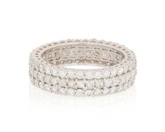 1034 A 14K White Gold and Diamond Eternity band Featuring three rows of round and princess-cut diamonds weighing approximately 1.44 carats  Size: 6 1/4 3.1 grams gross Estimate: $1,000 - $1,500