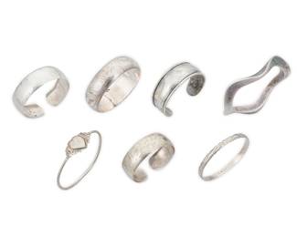 1202 Seven Silver Bracelets Comprising three cuffs and four bangles including a hinged bangle, each in various sizes and styles, including three with chased silver motifs, and three modernist style bracelets Variously marked for maker; six for sterling; one further marked for Mexico; one unmarked 8 pieces  Largest 8 in. inner C x 3/38 in.; Smallest 6 in. total inner C x 3/4 in. 123.9 grams gross Estimate: $200 - $300