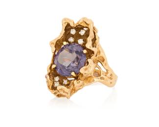 1176 A 14K Gold, Synthetic Color-Change Sapphire and Diamond Ring Of an organic design centering a round synthetic color-change sapphire and diamond ring  Size: 6 1/2 11.9 grams gross Estimate: $800 - $1,200