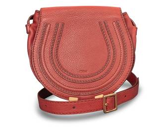1245 Chloé: A Vintage Marcie Leather Crossbody Saddle Bag Circa 2013 A small rounded bag in russet orange calfskin with gold-toned hardware, the flap with saddle topstitching and secured with leather strap tassels, and the interior lined with brown twill, with two pockets Embossed to inner pocket: Chloé / Made in Spain; embossed to inner tag: 03-13-60-65  7 x 7 1/2 x 3 in. approximately; strap drop 24 - 20 in. Estimate: $200 - $400