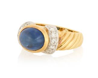 1180 An 18K Bi-Color Gold, Sapphire and Diamond Ring Centering an oval sapphire double cabochon weighing approximately 4.40 carats, accented by two rows of round diamonds  Size: 5 3/4 with sizing beads 9.7 grams gross Estimate: $1,500 - $2,000
