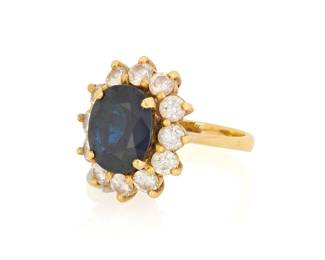 1086 An 18K Gold, Sapphire and Diamond Ring Centering an oval sapphire measuring approximately 8.43 x 6.94 mm, encircled by round diamonds weighing approximately 0.84 carat  Size: 2 1/2 4.1 grams gross Estimate: $800 - $1,200