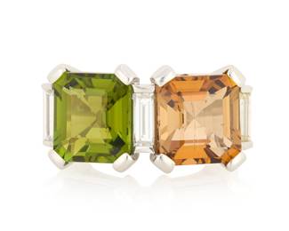 1150 A Platinum, Tourmaline and Diamond Ring Featuring two square emerald-cut green and orange tourmalines accented by three baguette diamonds  Size: 7 1/2 14.0 grams gross Estimate: $2,500 - $3,500