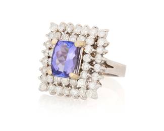 1148 A 14K White Gold, Tanzanite and Diamond Ring Centering a cushion mixed-cut tanzanite measuring approximately 10.25 x 7.68 mm, encircled by two rows of round diamonds weighing approximately 1.75 carats  Size: 6 1/4 13.6 grams gross Estimate: $1,500 - $2,000