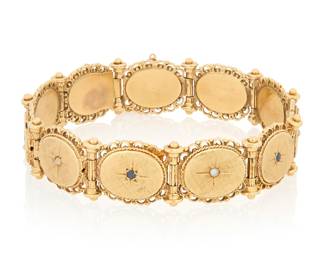 1170 A 14K Gold, Sapphire and Seed Pearl Bracelet Featuring oval etched links centering a star motif set with alternating seed pearls and round sapphires  Length: 7 3/4 in. 36.2 grams gross Estimate: $2,200 - $2,800