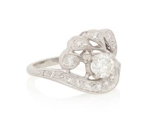 1033 A Platinum and Diamond Ring Featuring an openwork foliate design centering a round diamond weighing approximately 0.65 carat, accented by single-cut diamonds  Size: 6 1/4 7.9 grams gross Estimate: $1,500 - $2,000
