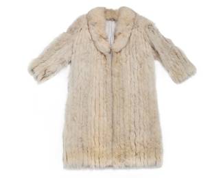 1261 A Vintage Fox Fur Coat Late 20th century A blond/cream fox fur wrap front coat with vertical striped fur alternating with suede inserts, shawl collar, front slash pockets, and silver satin lining  No size label; length: 48 in.; back width at underarms: 24 in.; back width at shoulders: 18 in; sleeves: 23 in. Estimate: $200 - $400