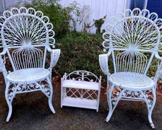 Two White Wicker Chairs And A Wicker Shelf