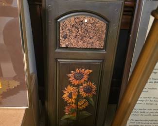  wooden wall organizer featuring a corkboard panel on top and a painted sunflower 