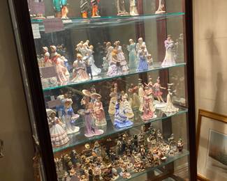 Lighted Curio cabinets with beautiful Armani and Lenox lady figurines