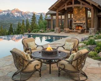Round outdoor fire pit table with cushioned swivel chairs, patio conversation furniture and fireside lounge seating.