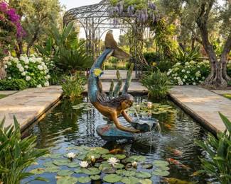 Mermaid fountain sculpture, decorative pond statuary and a statement water feature for a garden or courtyard.